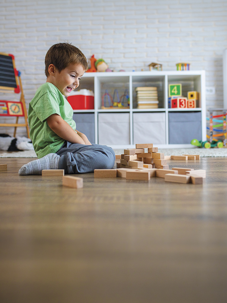 Family playing games in a living room with a hardwood floor